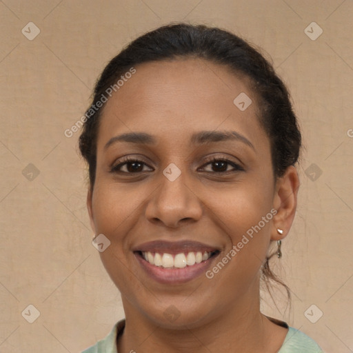 Joyful latino young-adult female with medium  brown hair and brown eyes