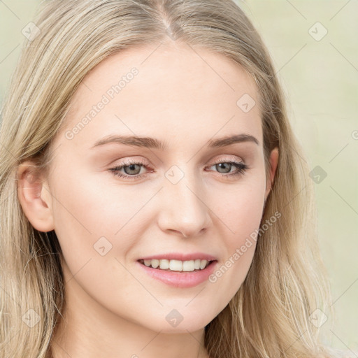 Joyful white young-adult female with long  brown hair and blue eyes