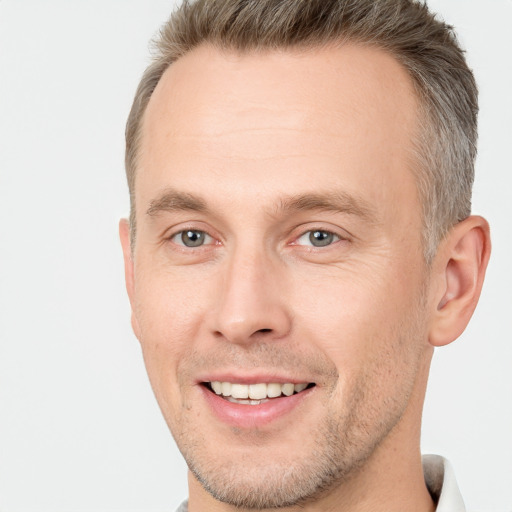 Joyful white adult male with short  brown hair and brown eyes