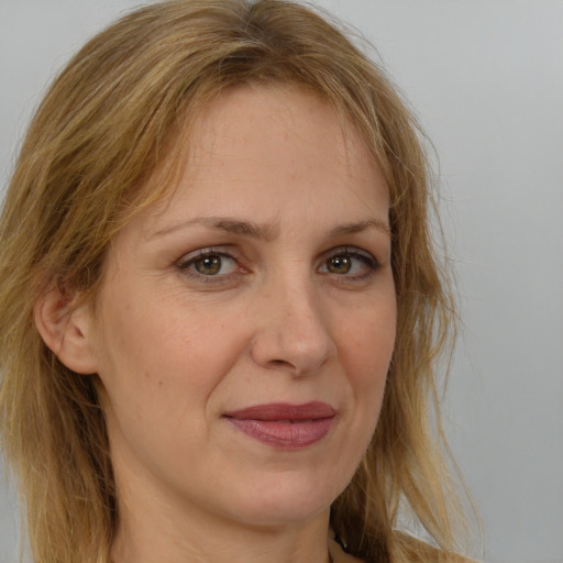 Joyful white adult female with long  brown hair and brown eyes