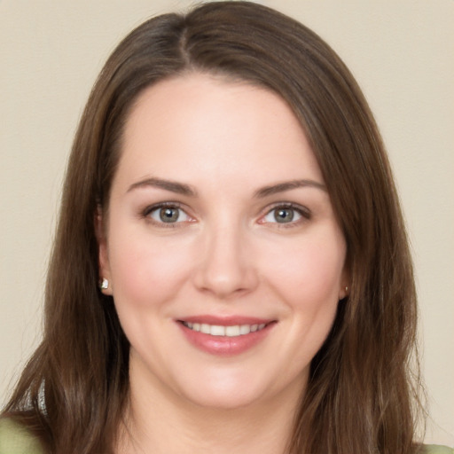 Joyful white young-adult female with long  brown hair and brown eyes