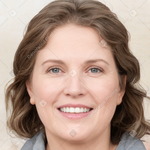 Joyful white adult female with medium  brown hair and blue eyes