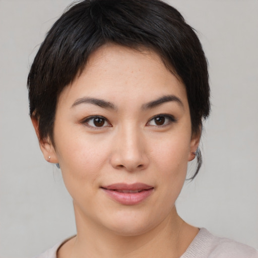 Joyful asian young-adult female with medium  brown hair and brown eyes