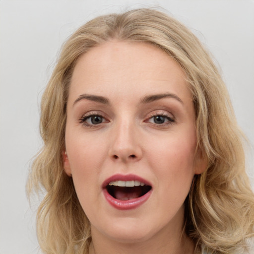 Joyful white young-adult female with medium  brown hair and blue eyes