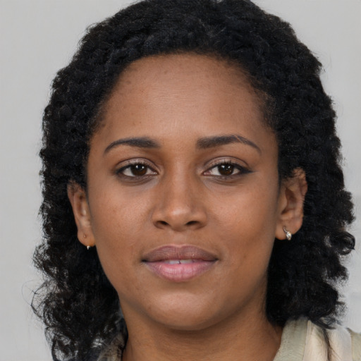 Neutral black young-adult female with long  brown hair and brown eyes