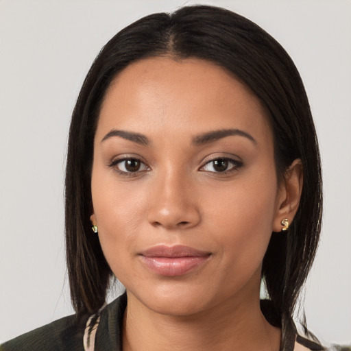 Joyful latino young-adult female with medium  brown hair and brown eyes