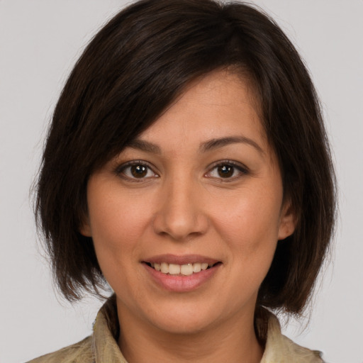 Joyful white young-adult female with medium  brown hair and brown eyes