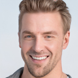 Joyful white young-adult male with short  brown hair and blue eyes