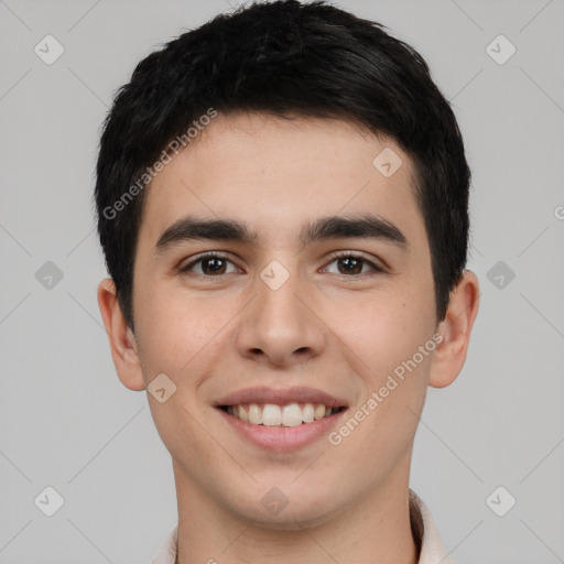 Joyful white young-adult male with short  black hair and brown eyes