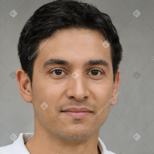Joyful latino young-adult male with short  brown hair and brown eyes