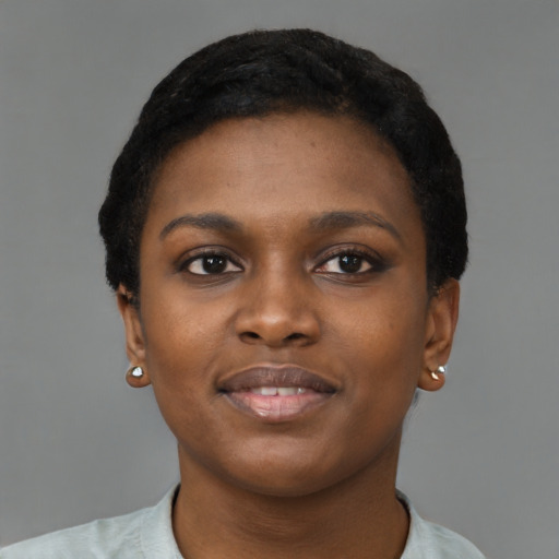 Joyful black young-adult female with short  black hair and brown eyes