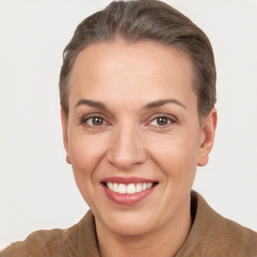 Joyful white adult female with short  brown hair and brown eyes