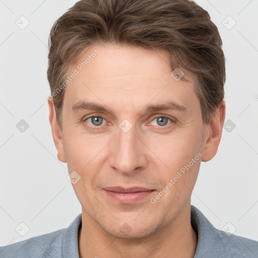 Joyful white adult male with short  brown hair and grey eyes