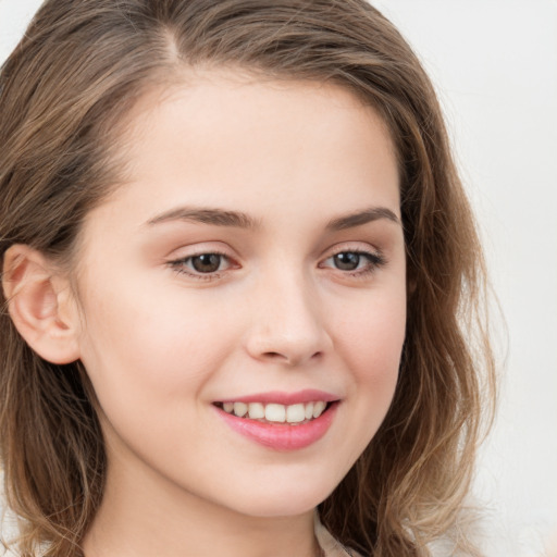 Joyful white child female with long  brown hair and brown eyes