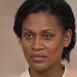 Joyful black adult female with medium  brown hair and brown eyes