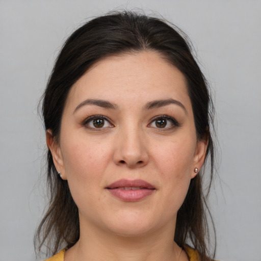 Joyful white young-adult female with medium  brown hair and brown eyes