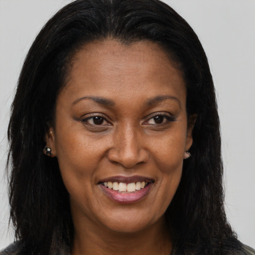 Joyful black young-adult female with long  brown hair and brown eyes