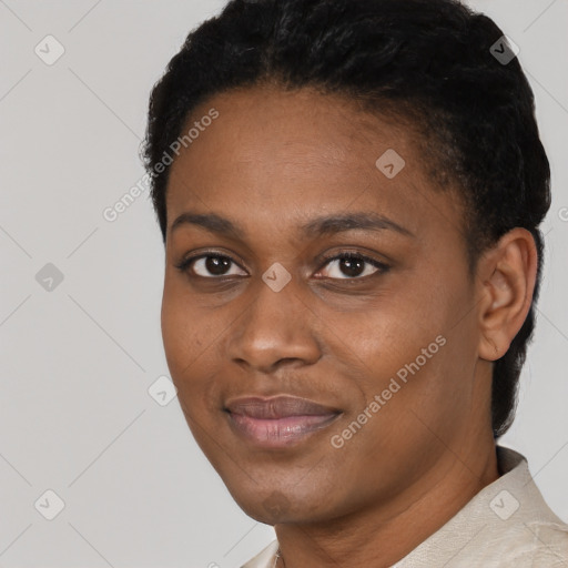 Joyful black young-adult female with short  black hair and brown eyes