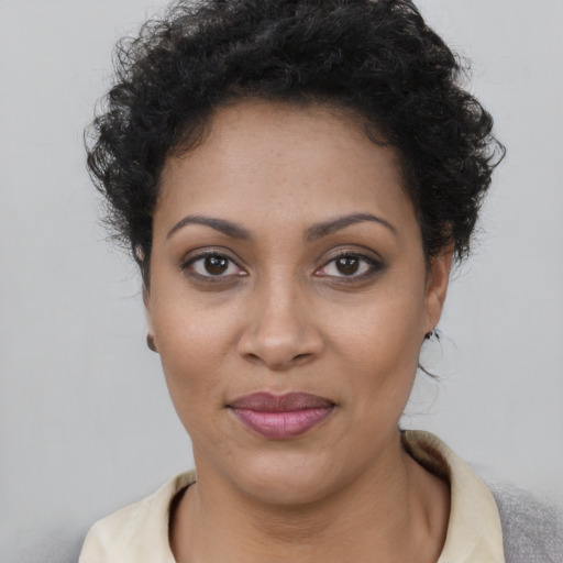 Joyful latino young-adult female with short  brown hair and brown eyes