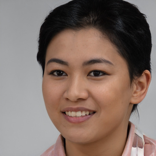 Joyful asian young-adult female with medium  brown hair and brown eyes