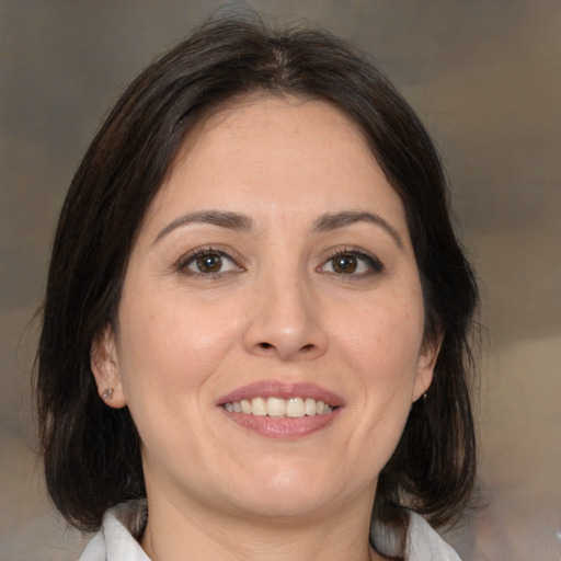 Joyful white adult female with medium  brown hair and brown eyes