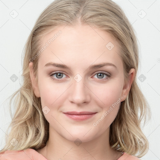 Joyful white young-adult female with long  brown hair and blue eyes