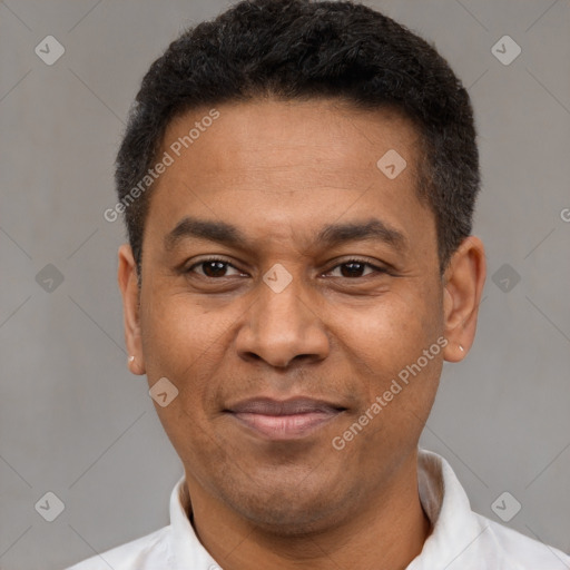 Joyful latino adult male with short  black hair and brown eyes