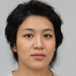 Joyful asian young-adult female with medium  black hair and brown eyes