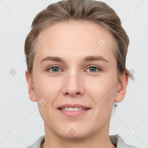 Joyful white young-adult female with short  brown hair and grey eyes