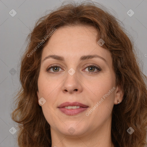 Joyful white adult female with long  brown hair and brown eyes