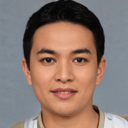 Joyful white young-adult male with short  black hair and brown eyes