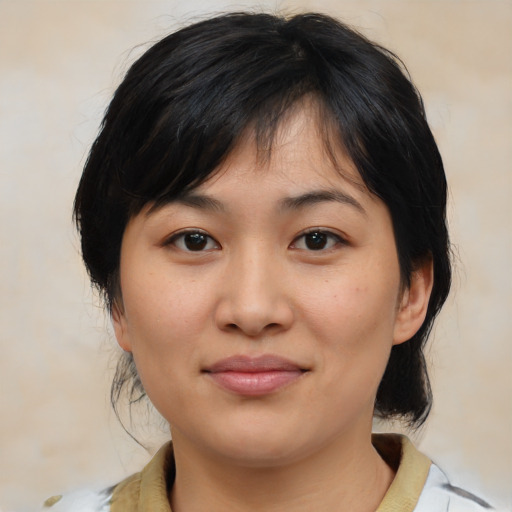 Joyful asian young-adult female with medium  brown hair and brown eyes
