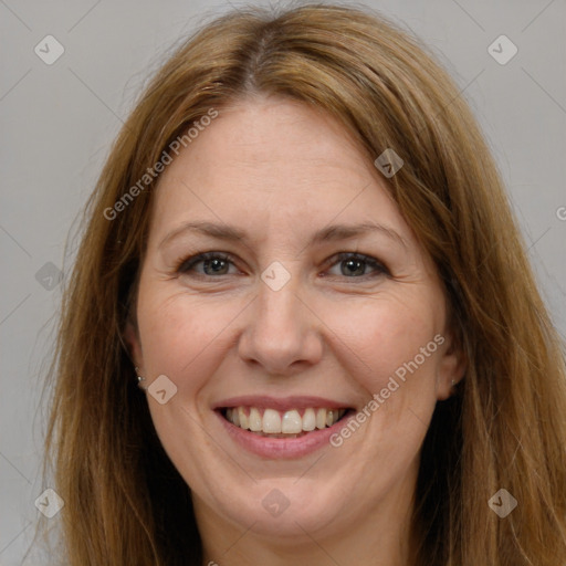 Joyful white adult female with long  brown hair and brown eyes