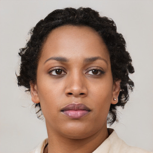 Neutral black young-adult female with long  brown hair and brown eyes