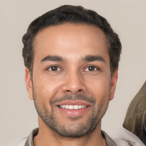 Joyful white young-adult male with short  brown hair and brown eyes