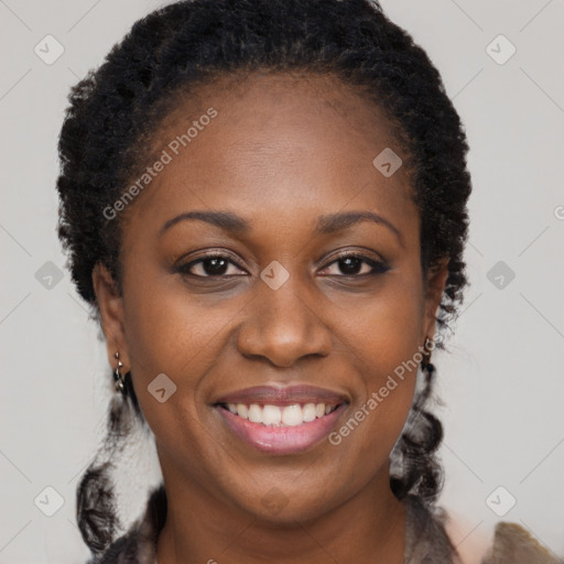 Joyful black adult female with long  brown hair and brown eyes