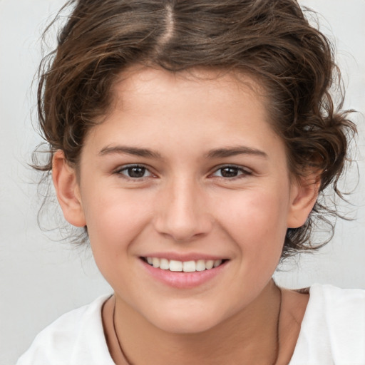 Joyful white child female with medium  brown hair and brown eyes