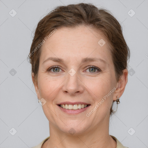 Joyful white adult female with short  brown hair and grey eyes