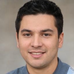 Joyful white young-adult male with short  black hair and brown eyes