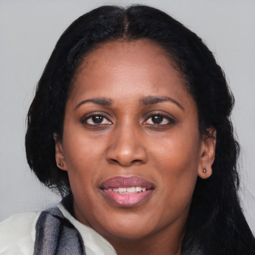 Joyful latino adult female with long  black hair and brown eyes