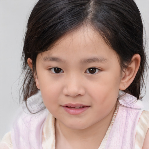 Joyful asian child female with medium  brown hair and brown eyes