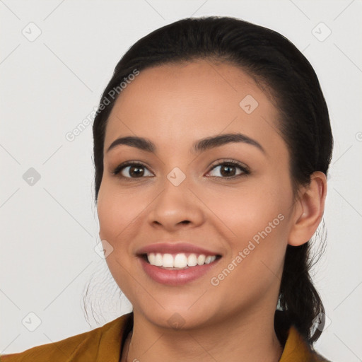 Joyful white young-adult female with long  black hair and brown eyes