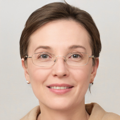 Joyful white adult female with short  brown hair and grey eyes