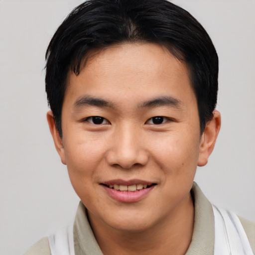 Joyful asian young-adult male with short  black hair and brown eyes