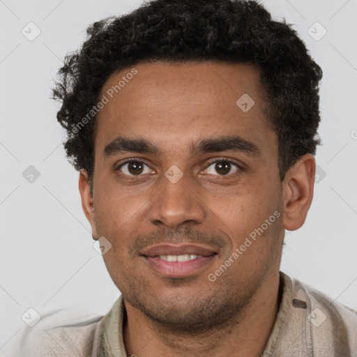 Joyful black young-adult male with short  brown hair and brown eyes