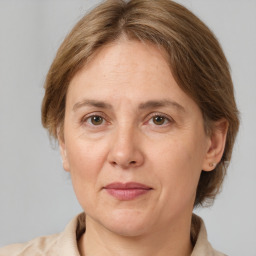 Joyful white adult female with medium  brown hair and grey eyes