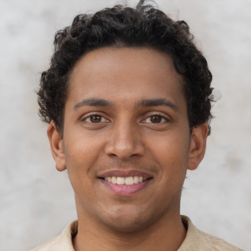 Joyful latino young-adult male with short  brown hair and brown eyes