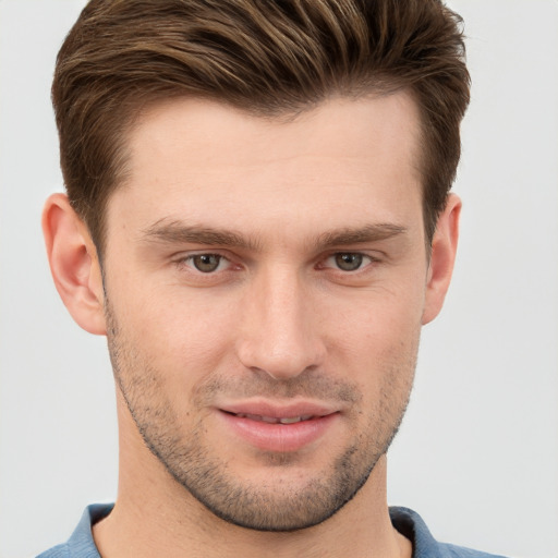 Joyful white young-adult male with short  brown hair and grey eyes