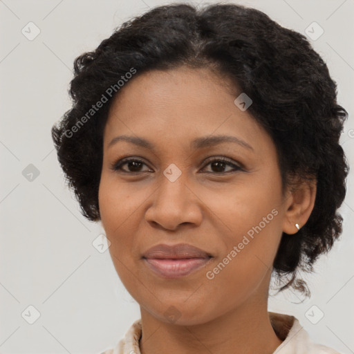 Joyful black adult female with medium  brown hair and brown eyes