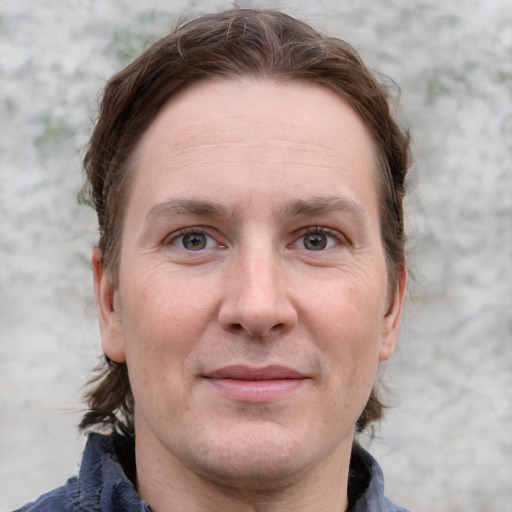 Joyful white adult male with medium  brown hair and grey eyes